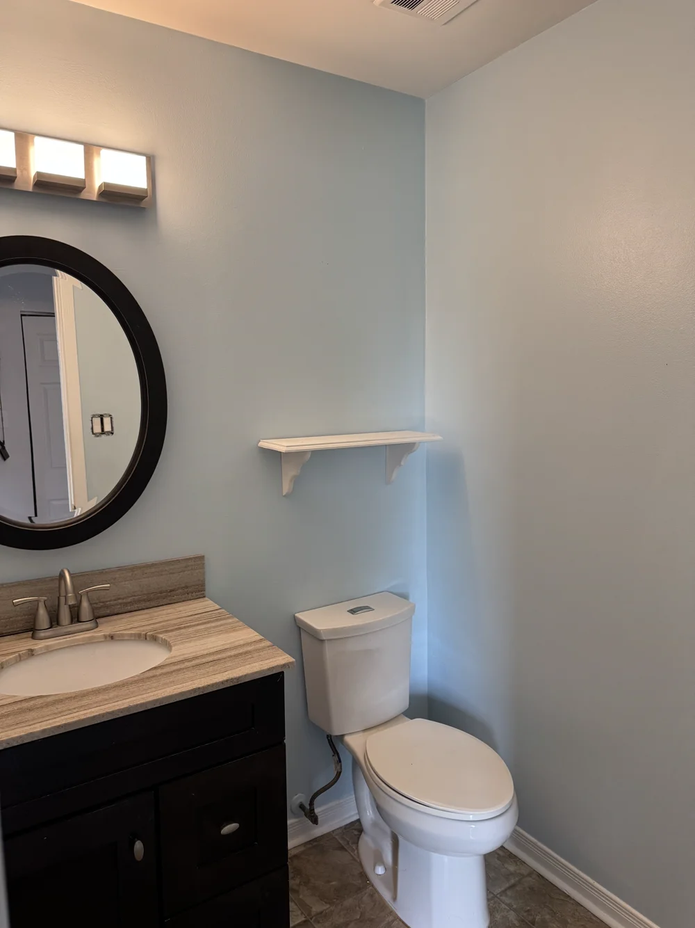 Bathroom after painting, with a lighter blue wall colour