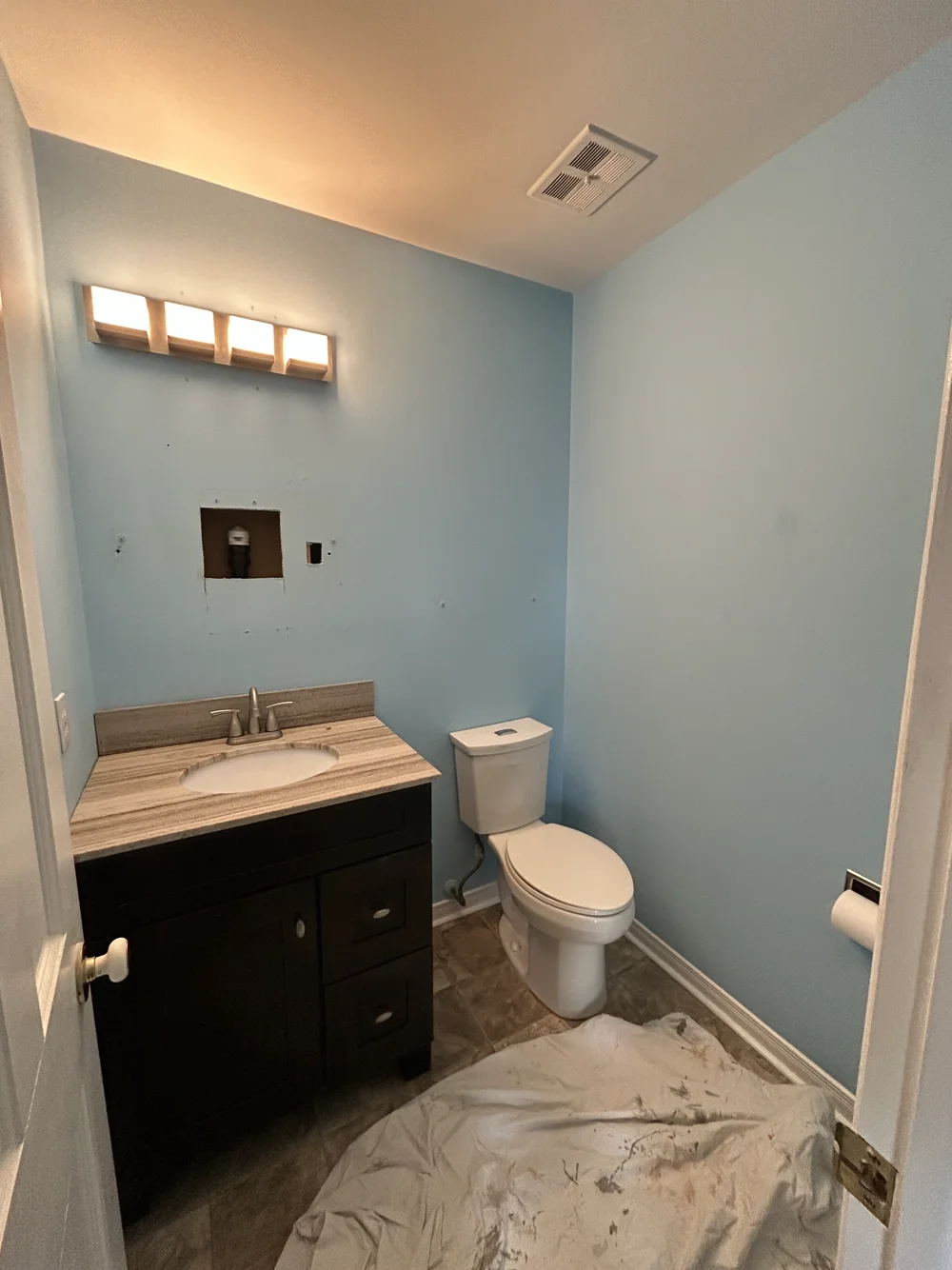 Bathroom before painting, with darker blue walls