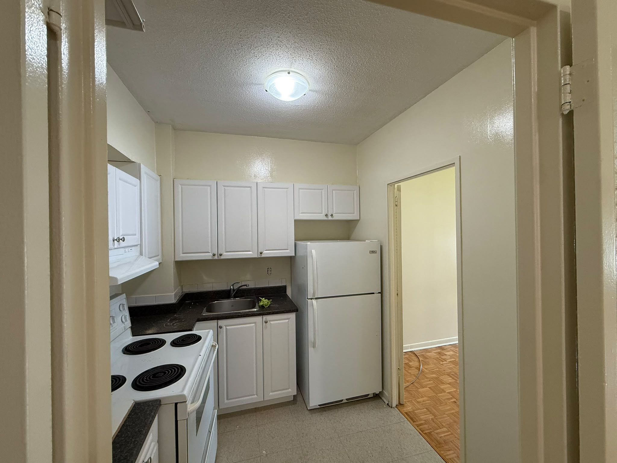 Apartment kitchen after painting — bright white walls