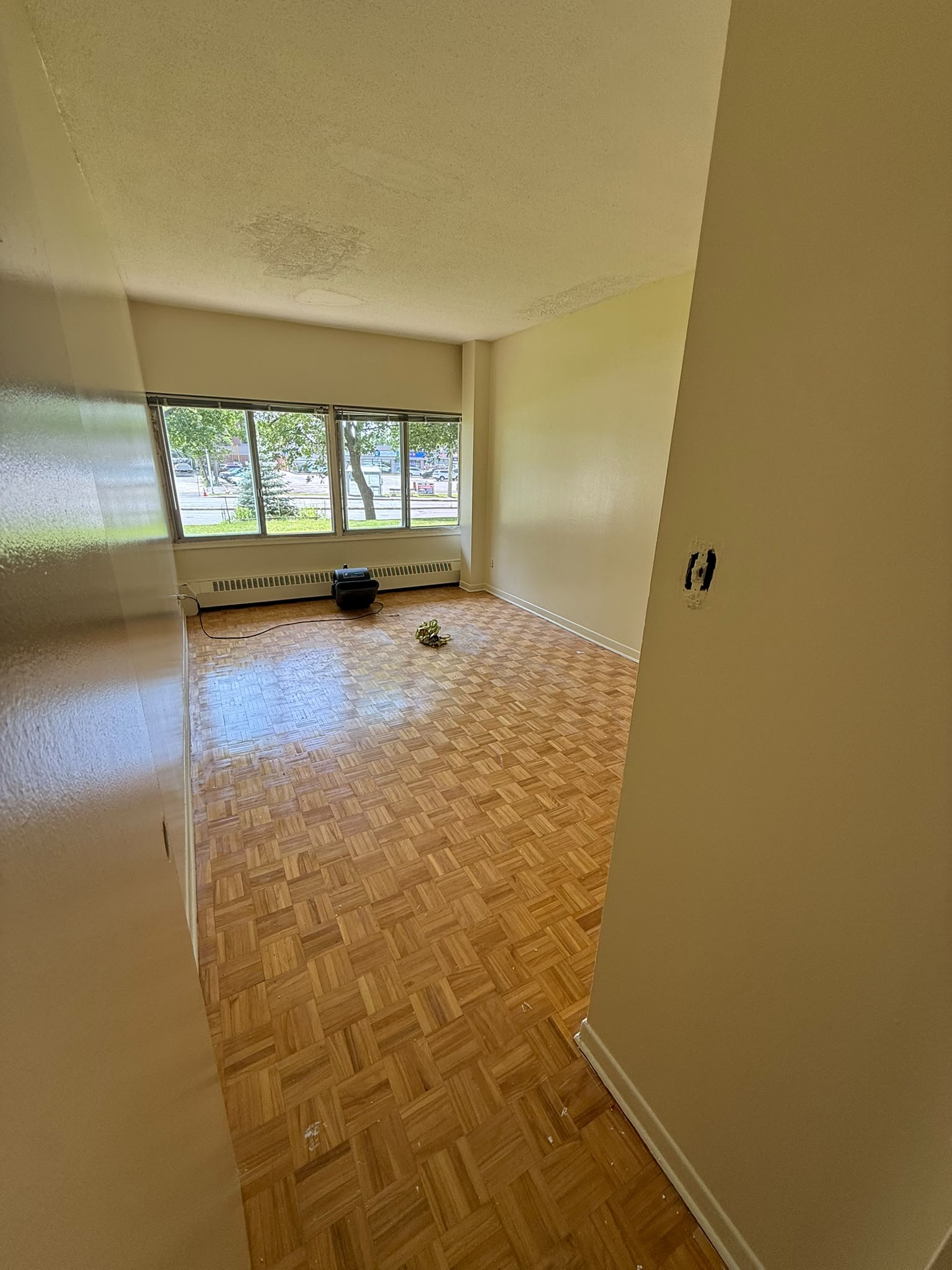 Apartment living room after painting — clean white walls