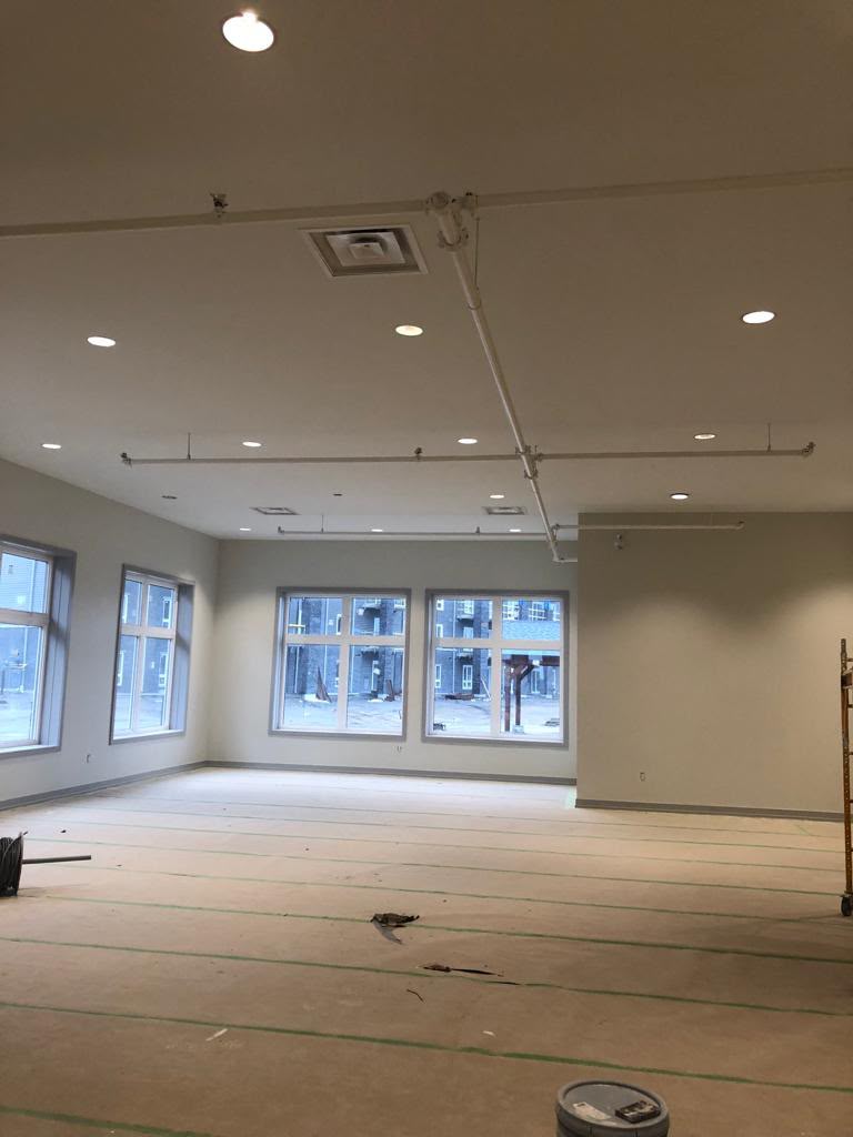 Commercial office space finished — clean painted walls and recessed lighting