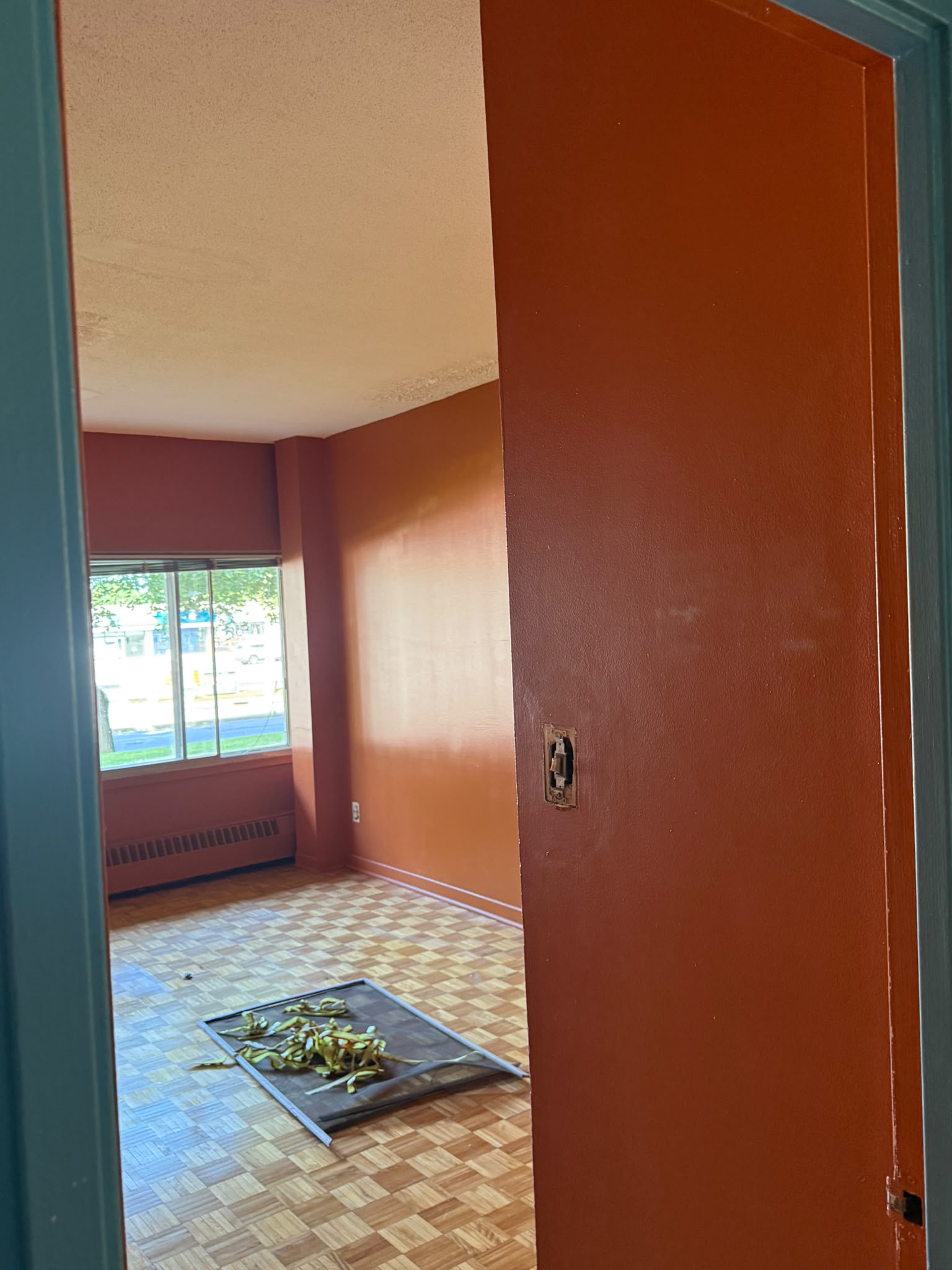 Apartment room before painting — terracotta orange walls