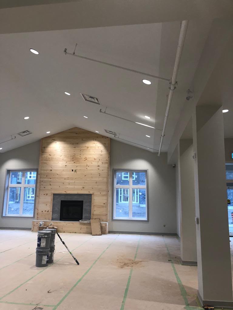 Shiplap fireplace feature wall during construction and finishing