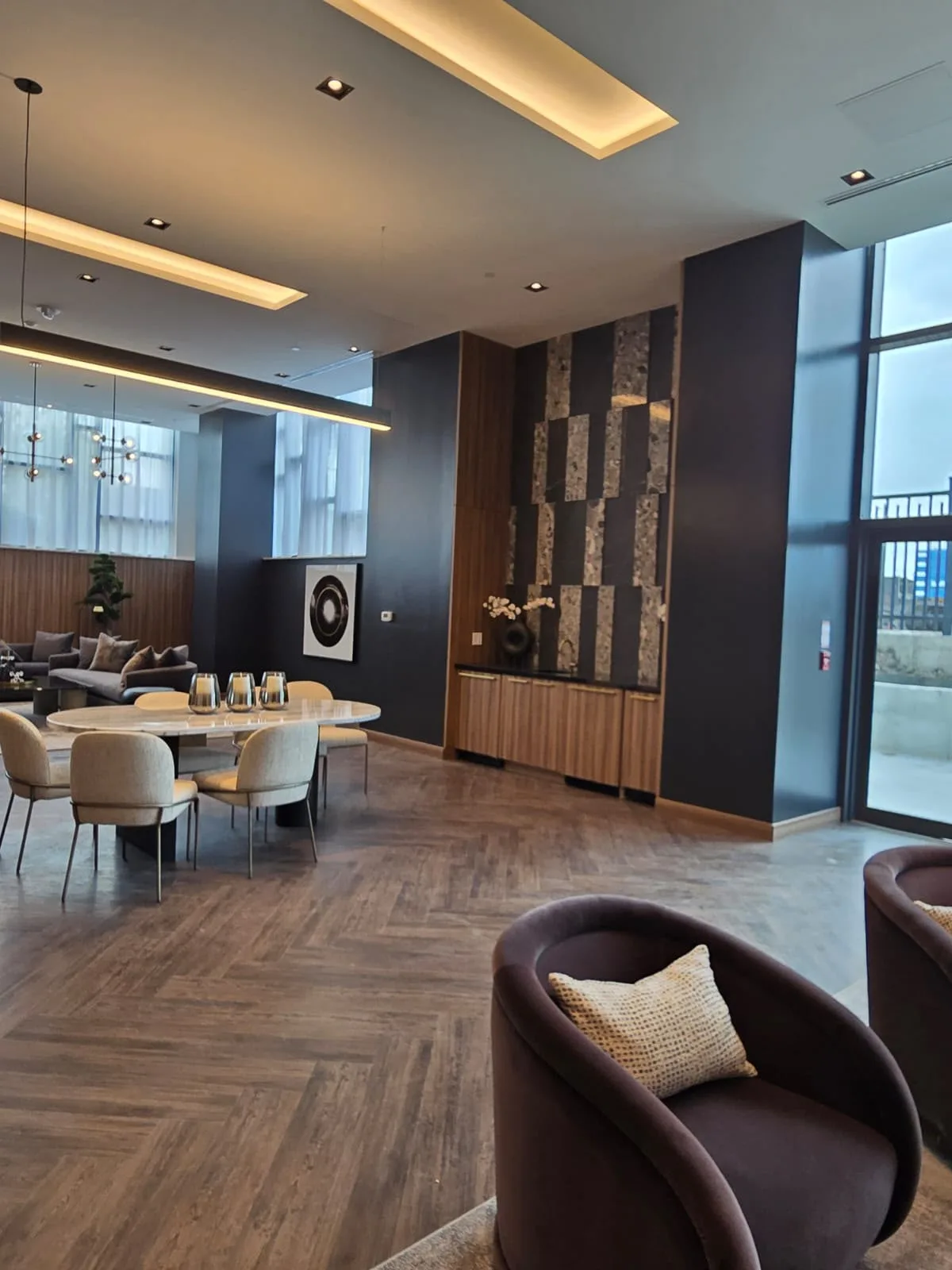 Completed commercial interior painting project in Ottawa — modern lounge with deep navy feature wall