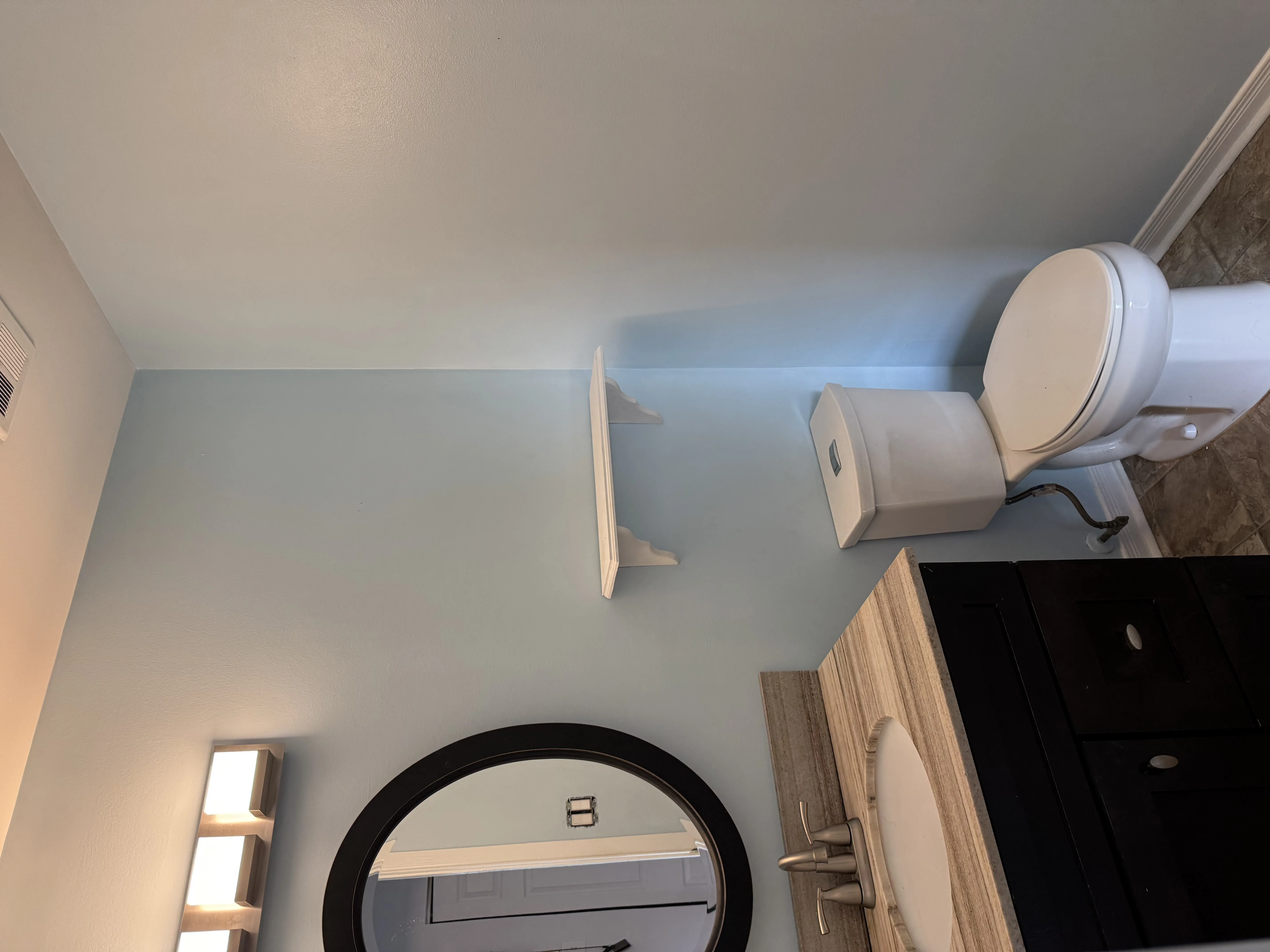Freshly painted bathroom interior in an Ottawa home — light blue walls with white trim